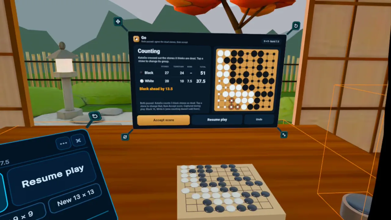 Headset view: the Go panel counting game 3, Black ahead by 13.5, above a 9 &times; 9 board on a desk in a tea room